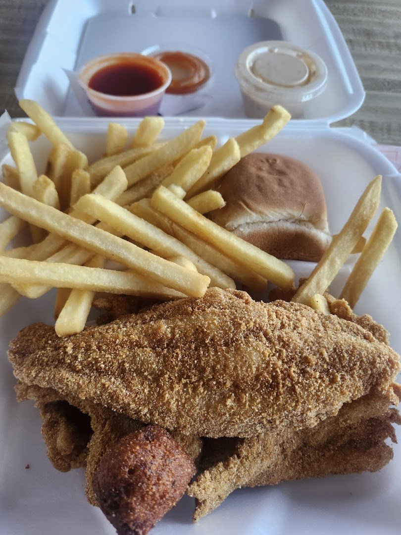 Golden shrimp and fish on white plates.