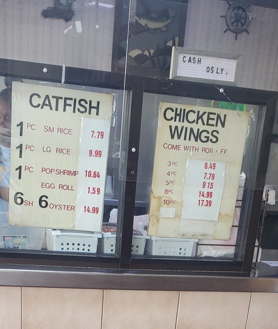 Simple menu listing fish, shrimp, and oysters.